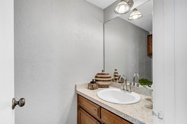 bathroom with vanity and a textured ceiling