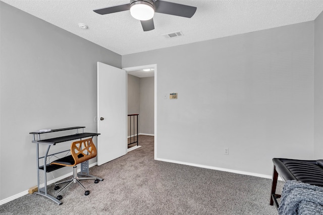 home office featuring carpet floors, a textured ceiling, and ceiling fan