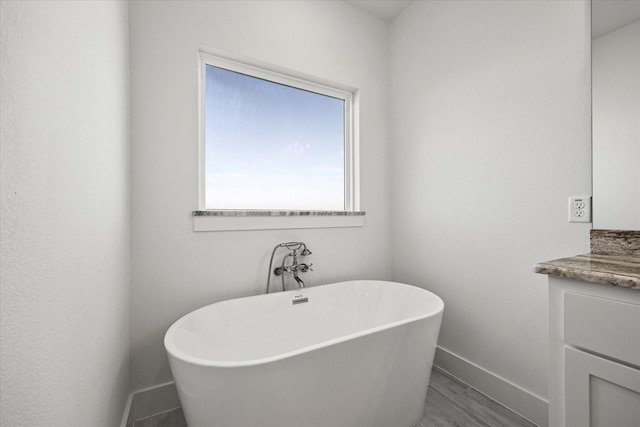 bathroom with vanity and a bathing tub