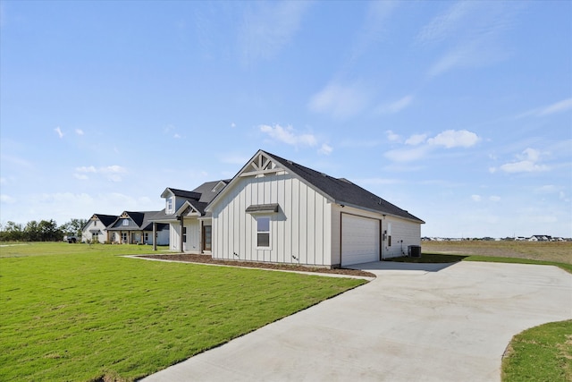 view of outbuilding featuring central AC unit and a lawn