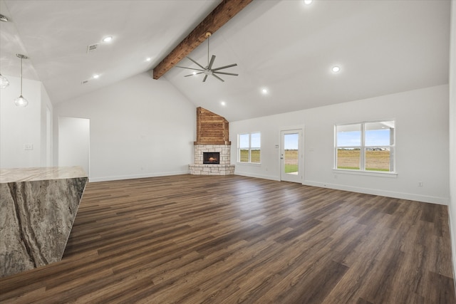 unfurnished living room featuring dark hardwood / wood-style floors, high vaulted ceiling, a fireplace, ceiling fan, and beam ceiling