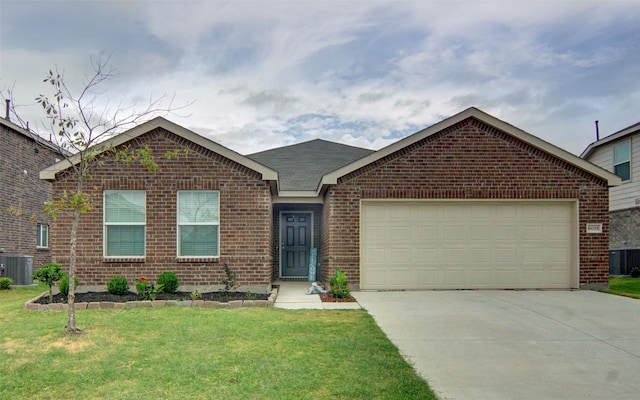 view of front of property with a front yard, a garage, and central AC