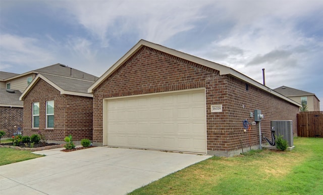 view of front facade with central AC unit, a garage, and a front yard