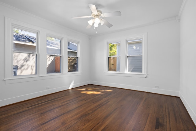 empty room with ornamental molding, dark hardwood / wood-style flooring, and ceiling fan