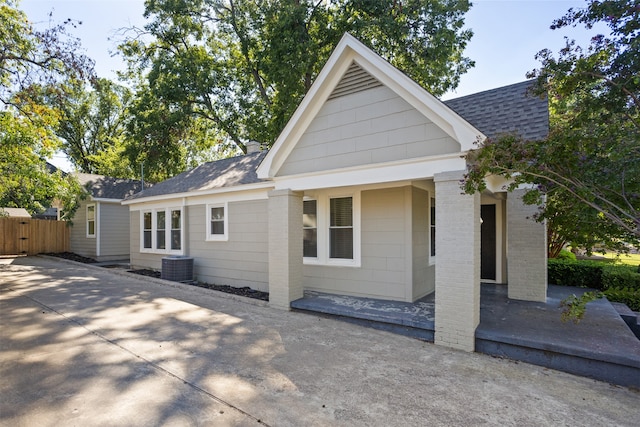 view of front of property with cooling unit and a patio area