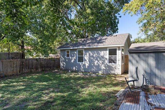 exterior space with a storage shed and a lawn