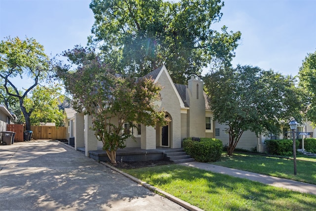 obstructed view of property featuring a front lawn