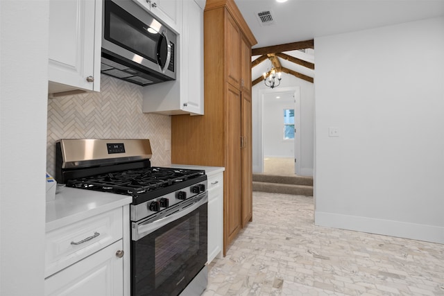 kitchen with white cabinets, an inviting chandelier, stainless steel appliances, vaulted ceiling with beams, and backsplash