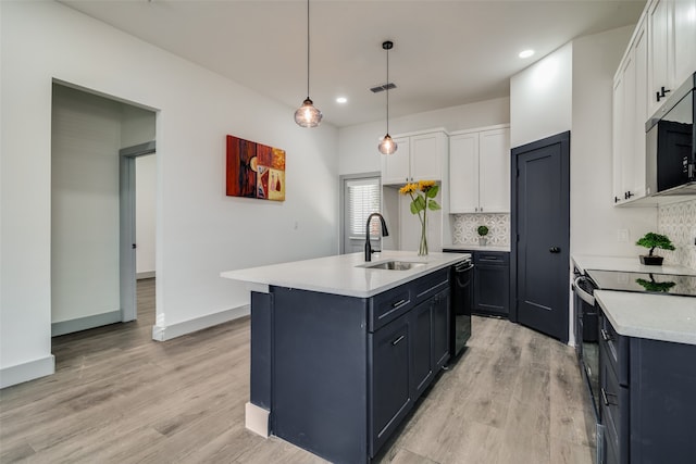 kitchen featuring a center island with sink, sink, light hardwood / wood-style flooring, and white cabinets