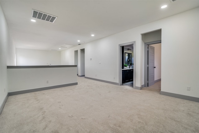 spare room with light colored carpet