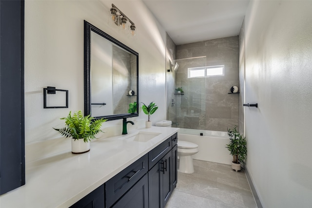 full bathroom with tile patterned flooring, tiled shower / bath combo, vanity, and toilet