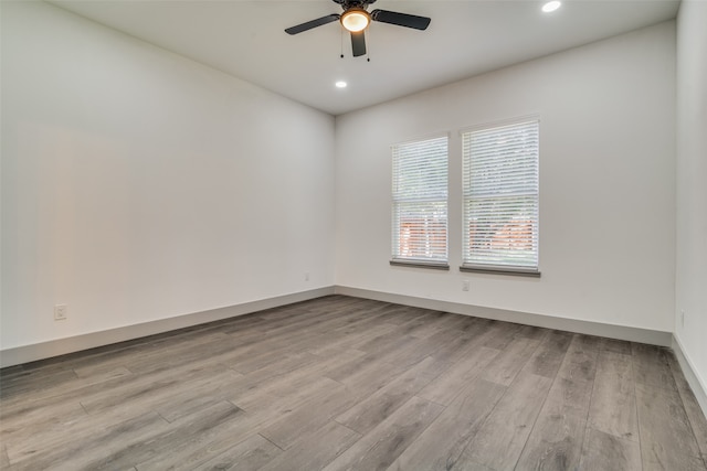 spare room with ceiling fan and light hardwood / wood-style flooring