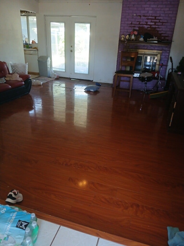 living room featuring hardwood / wood-style floors, a fireplace, and french doors