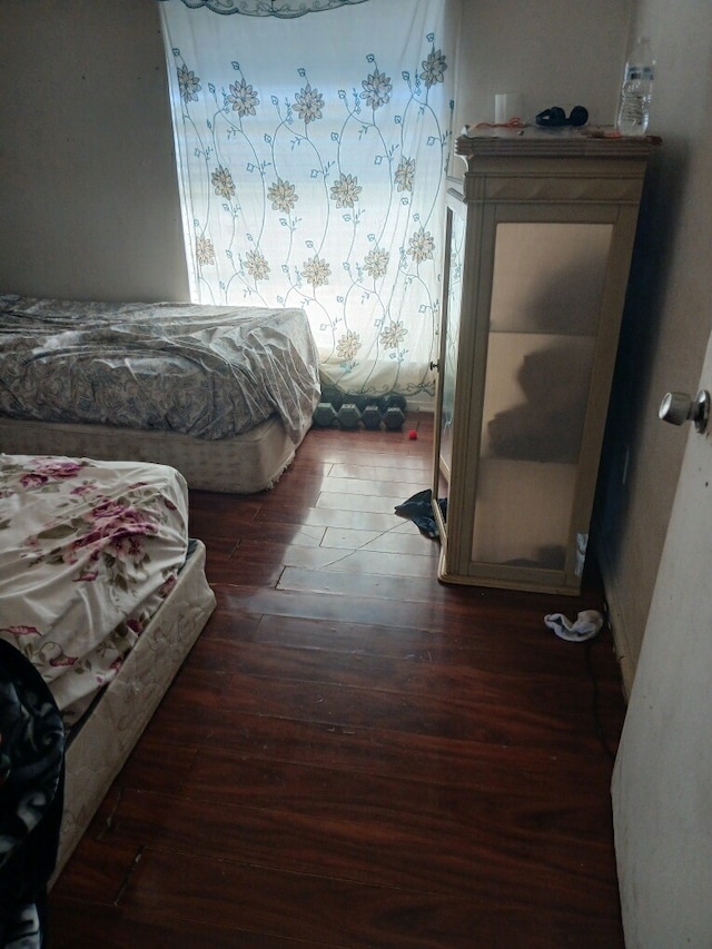 bedroom featuring dark hardwood / wood-style flooring