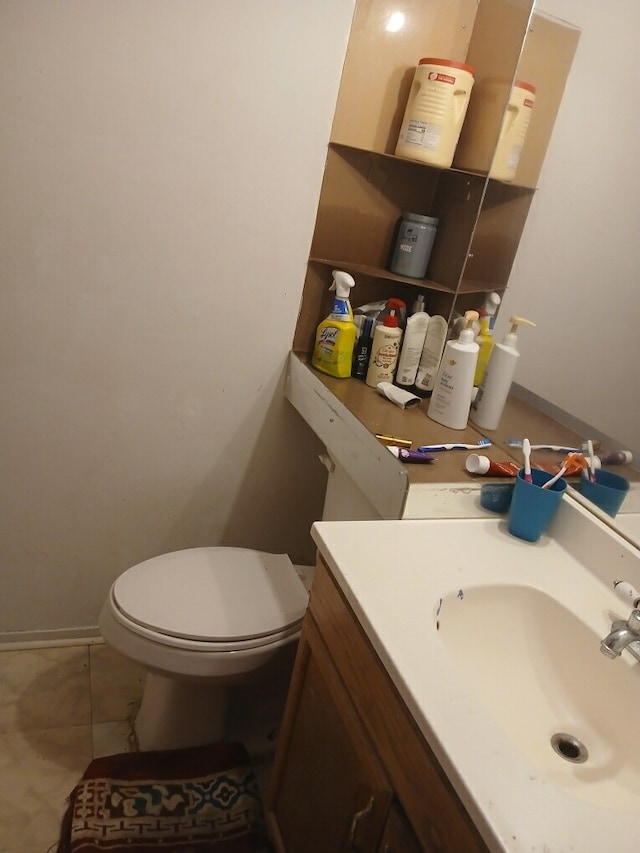 bathroom featuring tile patterned floors, vanity, and toilet