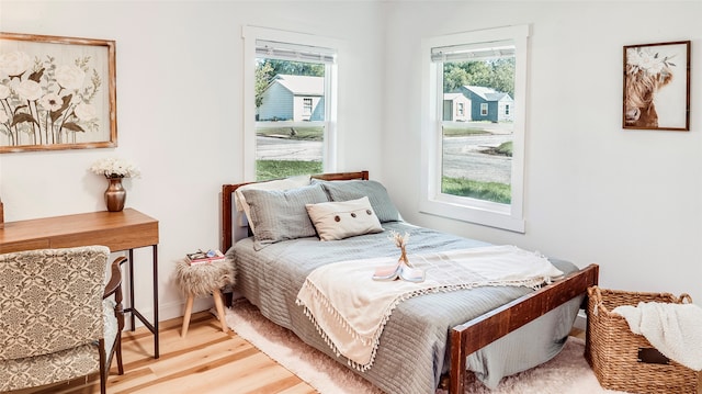 bedroom featuring light hardwood / wood-style flooring and multiple windows