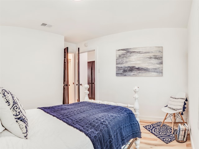 bedroom with wood-type flooring