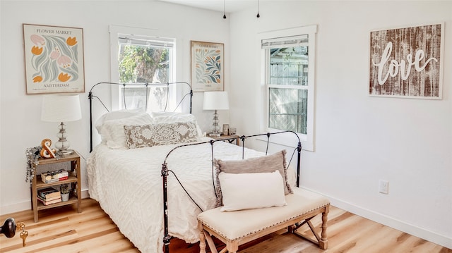 bedroom with hardwood / wood-style floors