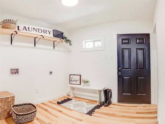 clothes washing area featuring washer hookup, hookup for an electric dryer, and hardwood / wood-style flooring