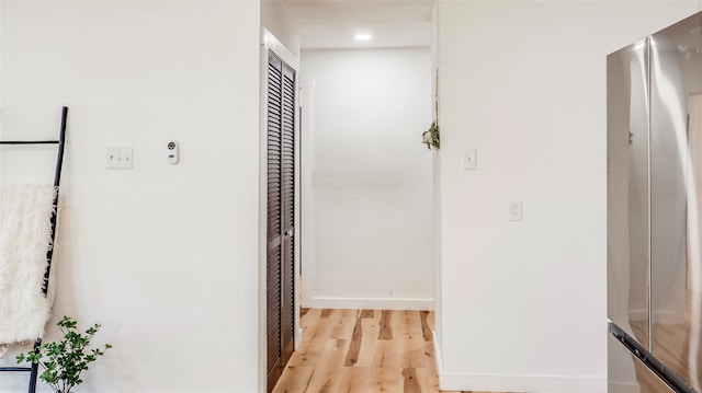 corridor with light hardwood / wood-style floors