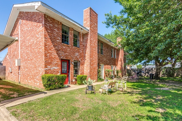 view of side of home with a lawn