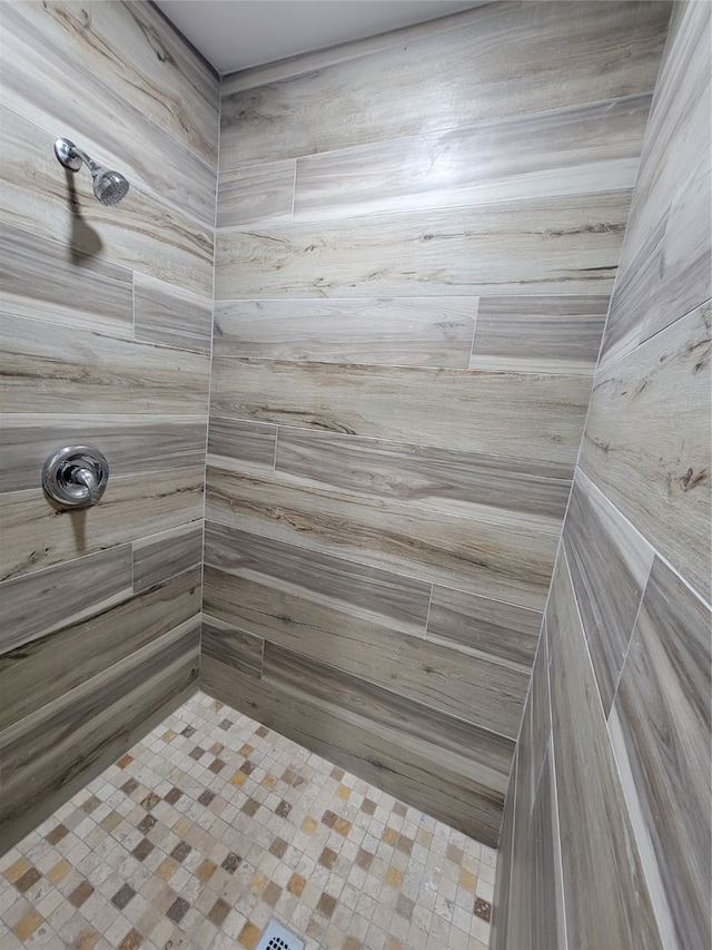 bathroom with a tile shower