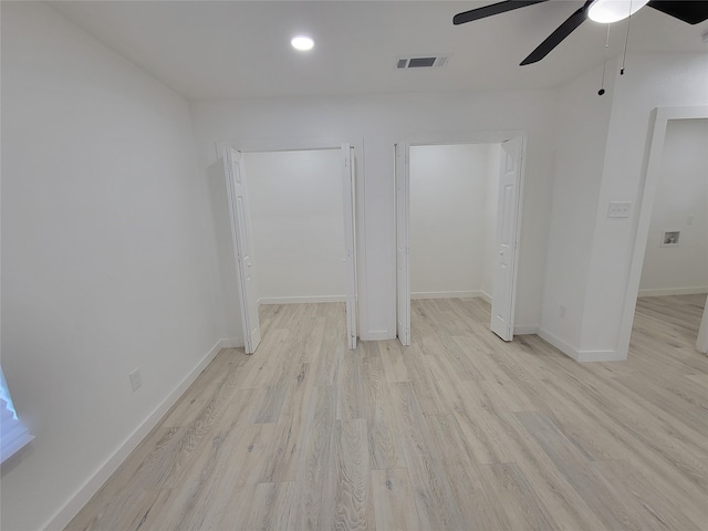 empty room with light hardwood / wood-style floors and ceiling fan