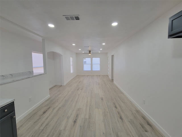 unfurnished living room featuring a wealth of natural light and light wood-type flooring