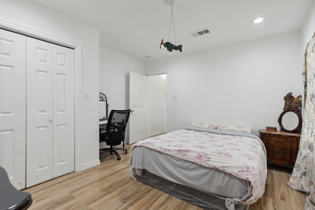 bedroom featuring a closet and light wood-type flooring