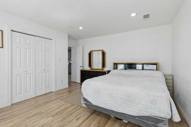 bedroom featuring light wood-type flooring and a closet