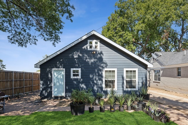 rear view of property with a yard