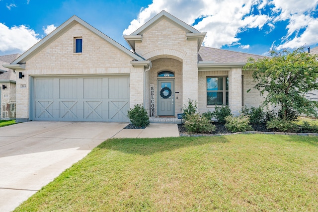 view of front of property with a front lawn and a garage