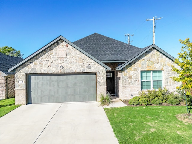 view of front of home with a garage and a front lawn