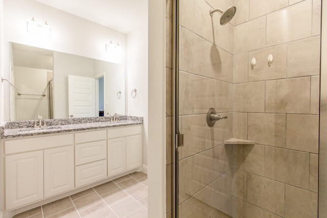 bathroom featuring tile patterned floors, an enclosed shower, and vanity