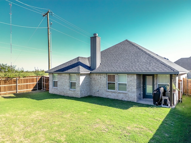 back of property with a lawn