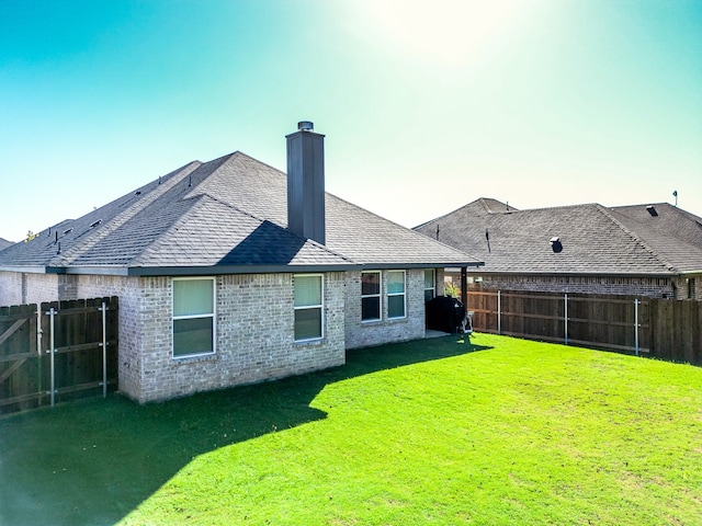 rear view of house with a lawn