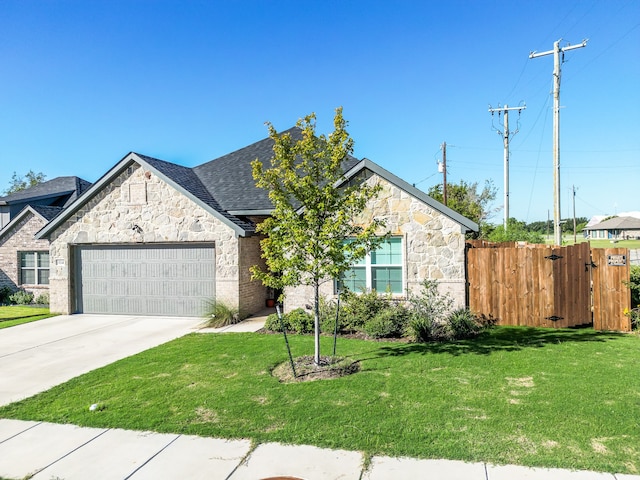 view of front of property featuring a garage and a front lawn