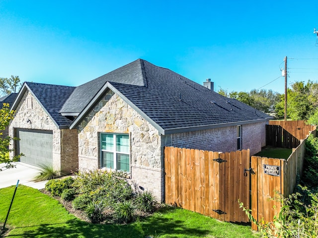 view of property exterior featuring a lawn and a garage