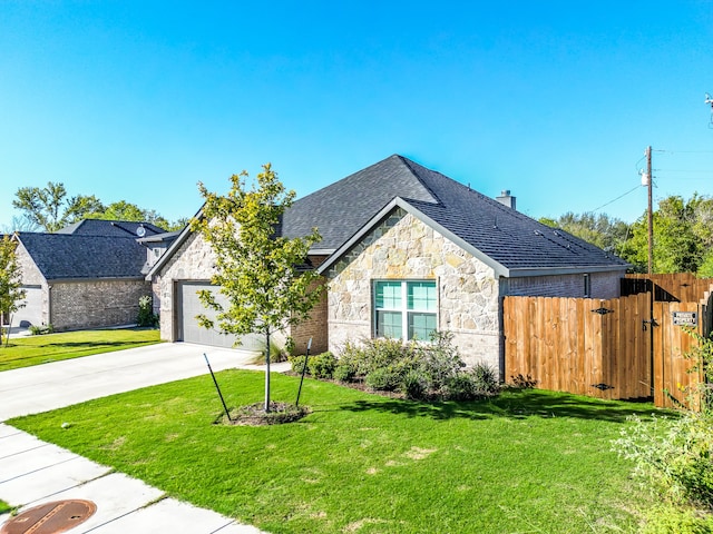 view of front of property with a front yard and a garage