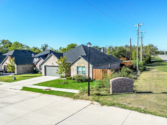 view of front of property with a garage and a front lawn