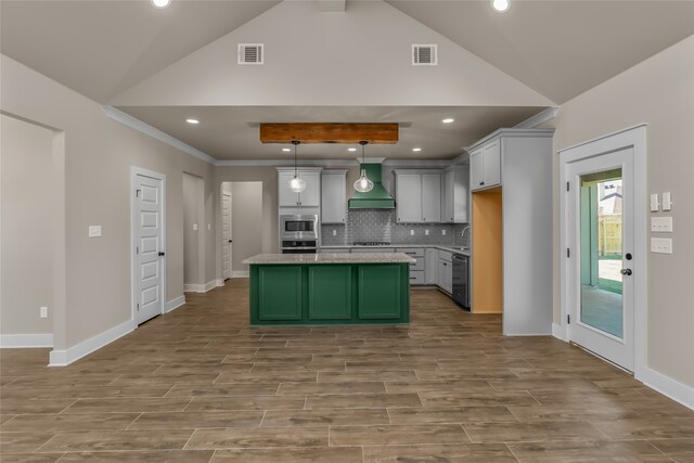 kitchen with light wood-type flooring, a center island, vaulted ceiling with beams, decorative light fixtures, and premium range hood