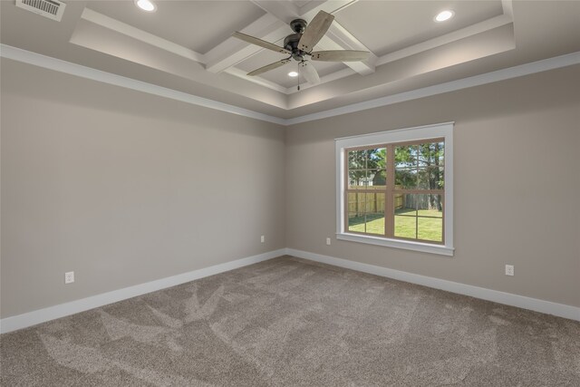 carpeted spare room with ceiling fan, beam ceiling, ornamental molding, and coffered ceiling