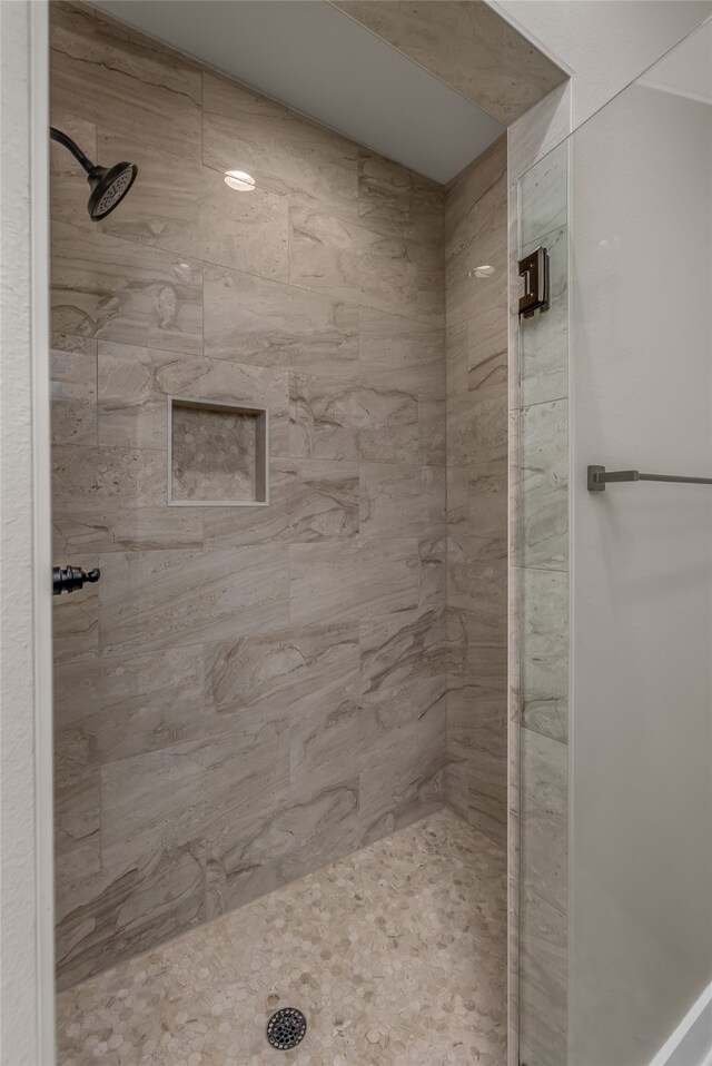 bathroom with tiled shower