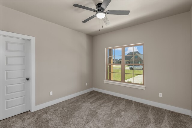 spare room with ceiling fan and carpet flooring