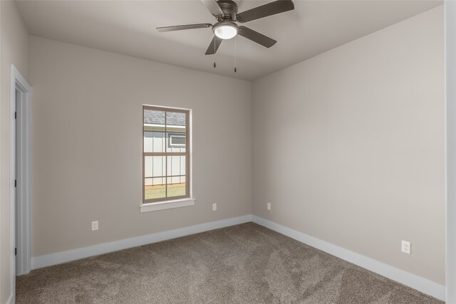 spare room featuring carpet and ceiling fan