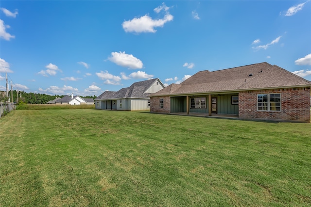 back of house with a yard