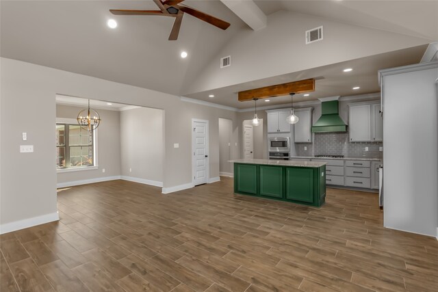 kitchen with pendant lighting, premium range hood, and hardwood / wood-style flooring