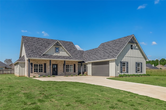 view of front of property with a front yard and a garage