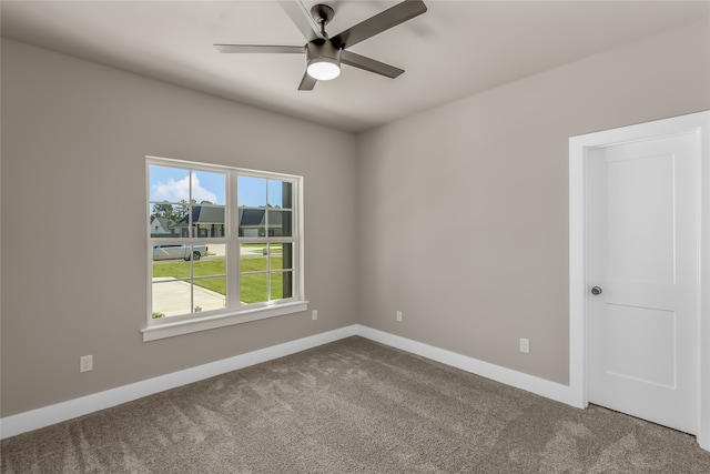 carpeted empty room featuring ceiling fan