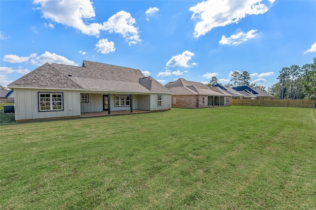 rear view of house with a lawn